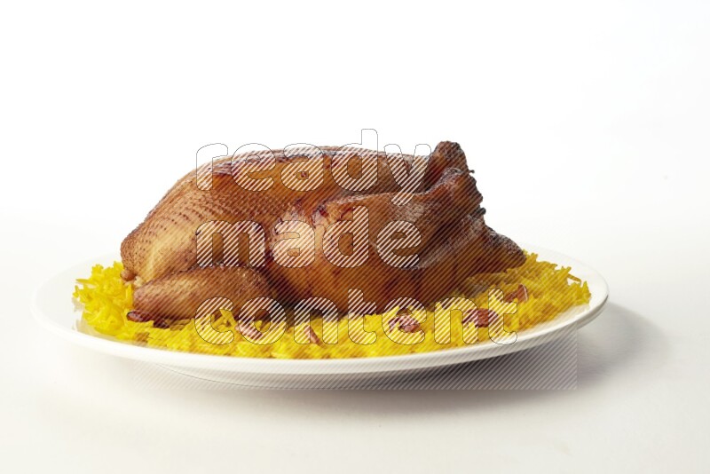 yellow  basmati Rice with  whole roasted chicken on a white rounded plate direct on white background