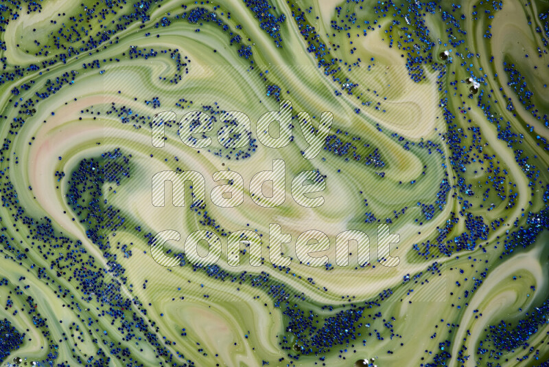 لقطة مقربة لبريق أزرق متلألئ منتشر على خلفية من اللون الأزرق والأخضر في حركات دائرية