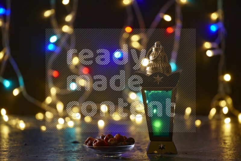A traditional ramadan lantern surrounded by glowing fairy lights in a dark setup
