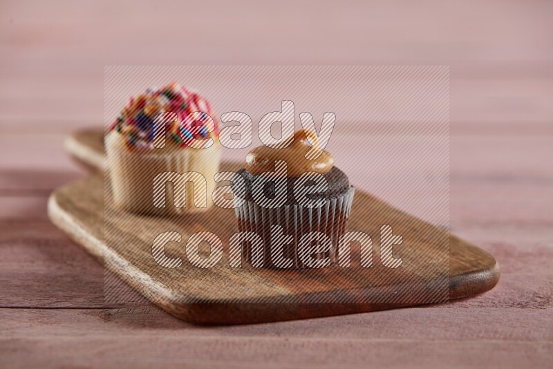 Chocolate mini cupcake topped with peanut butter on a wooden board