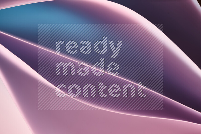 This image showcases an abstract paper art composition with paper curves in blue, purlpe and pink gradients created by colored light