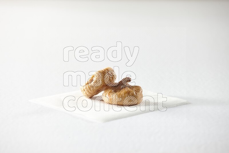 Two dried figs on a piece of paper on a white background in different angles