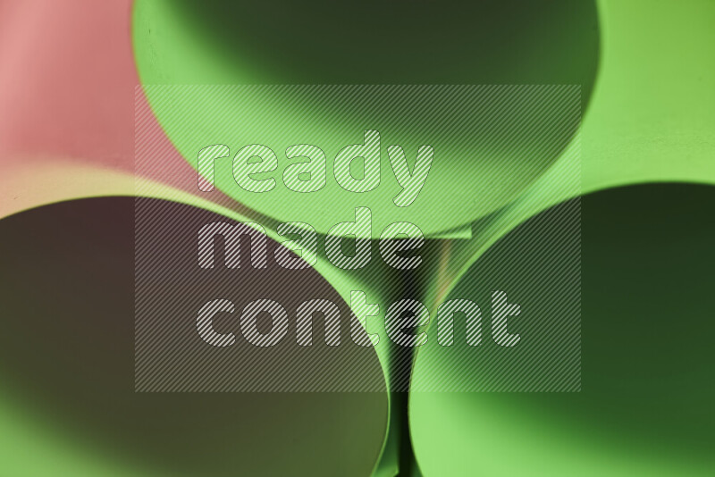 The image shows an abstract paper art with circular shapes in varying shades of green and pink