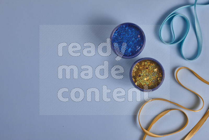A yellow and blue collection of sewing and tailoring tools arranged on a blue background