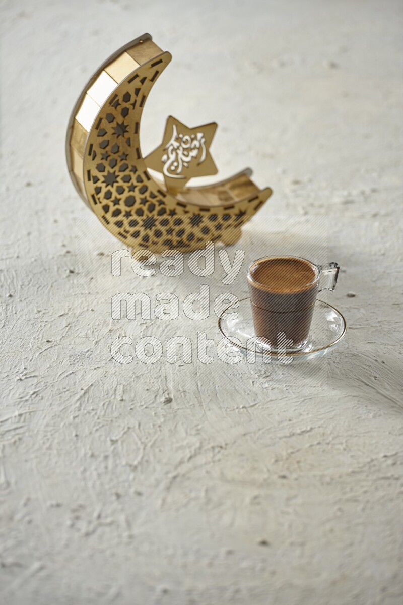 A wooden golden crescent lantern with different drinks, dates, nuts, prayer beads and quran on white background