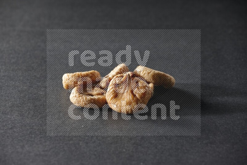 Dried figs on a black background in different angles