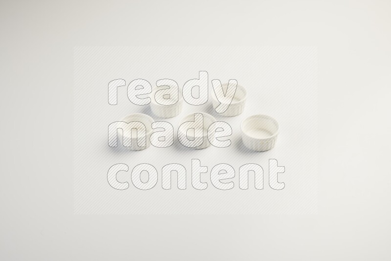 white ceramic round sauce dish on white countertop
