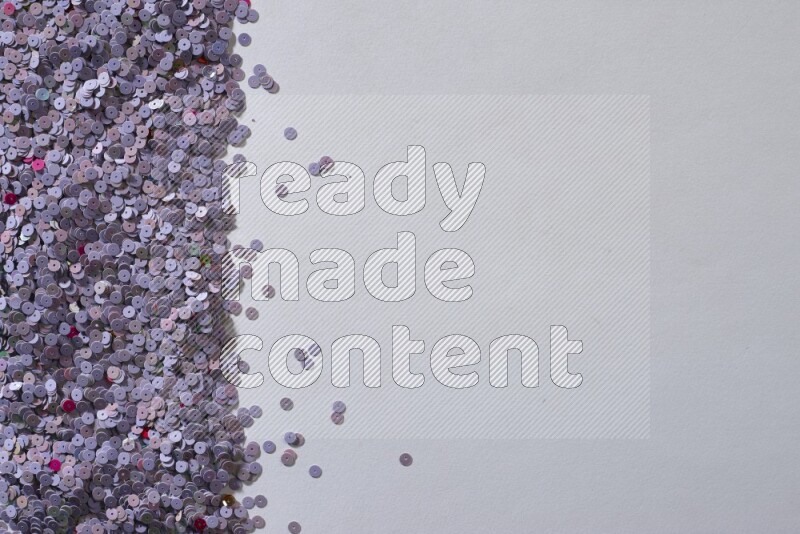 Multicolored flat sequins on grey background