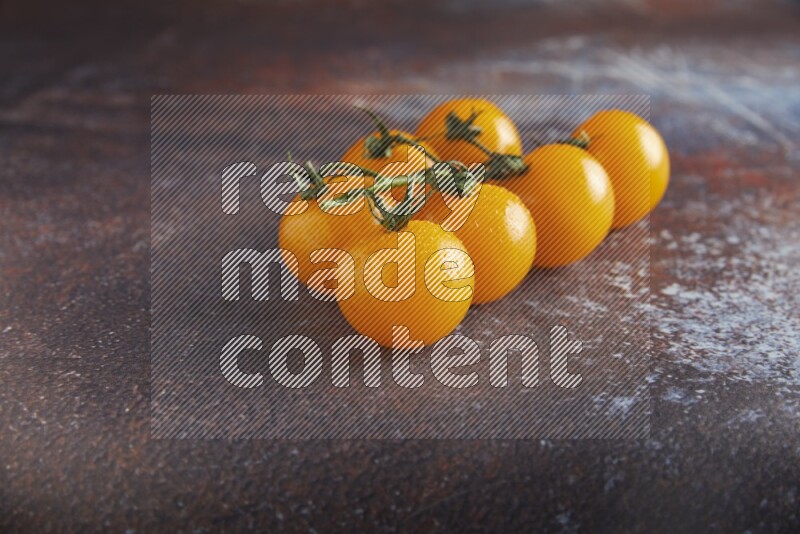 Yellow cherry tomato vein on reddish rustic metal background 45 degree
