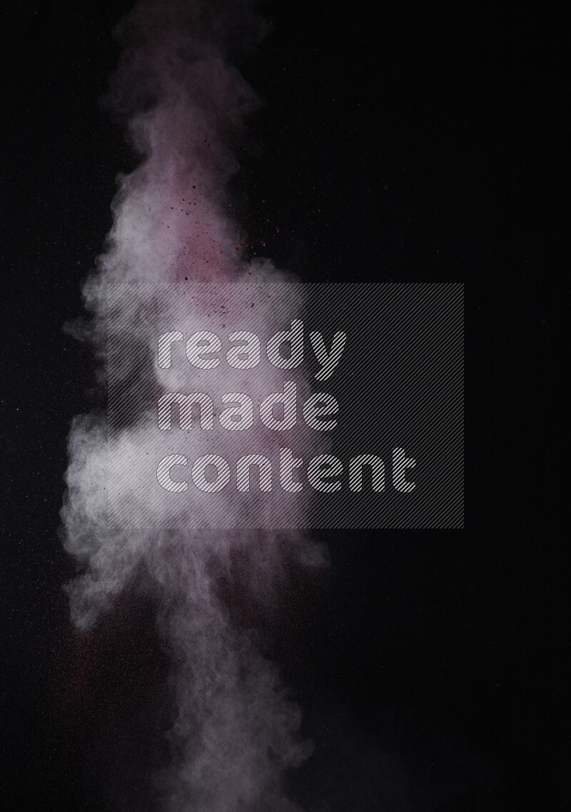 A side view of red powder explosion on black background