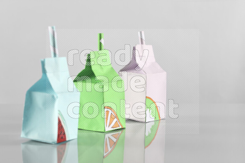 Origami juice box on grey background