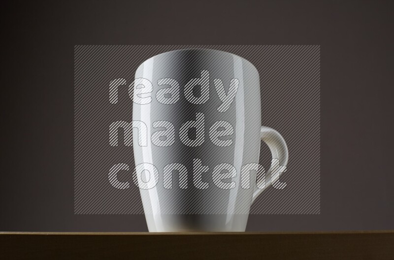 Low angle shot of a white cup on grey background