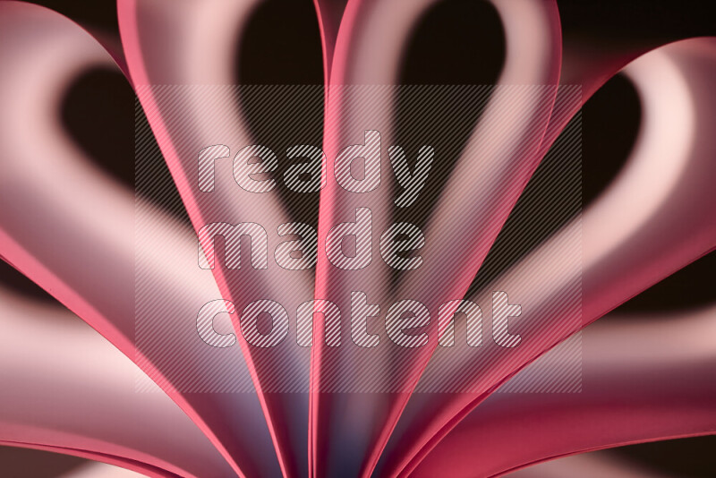 An abstract art piece displaying smooth curves in white and pink gradients created by colored light