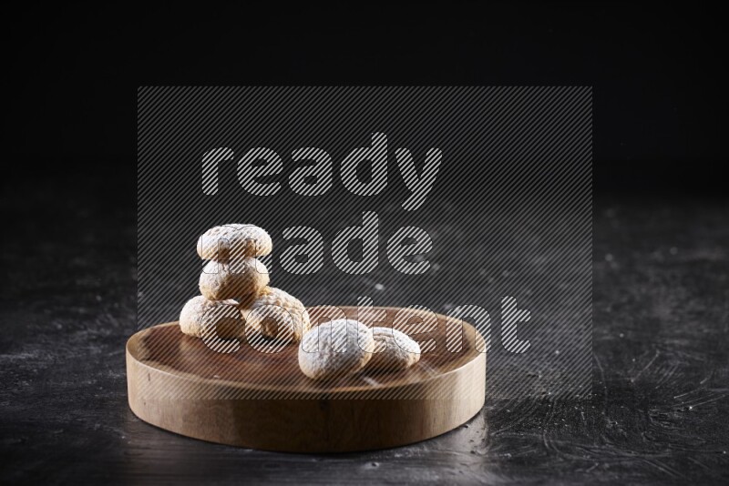 Kahk on a serving plate on a black background