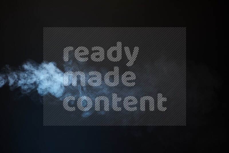 Heavy smoke in blue isolated on black background