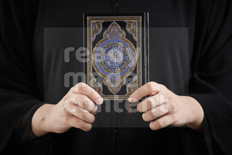 امرأة تحمل بيديها مصحف القرآن في أوضاع متعددة