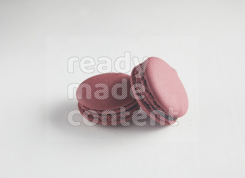 45º Shot of two Red Cherry macarons on white background