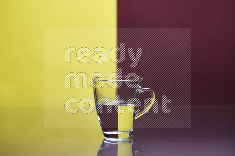 The image features a clear glassware filled with water, set against yellow and dark red background