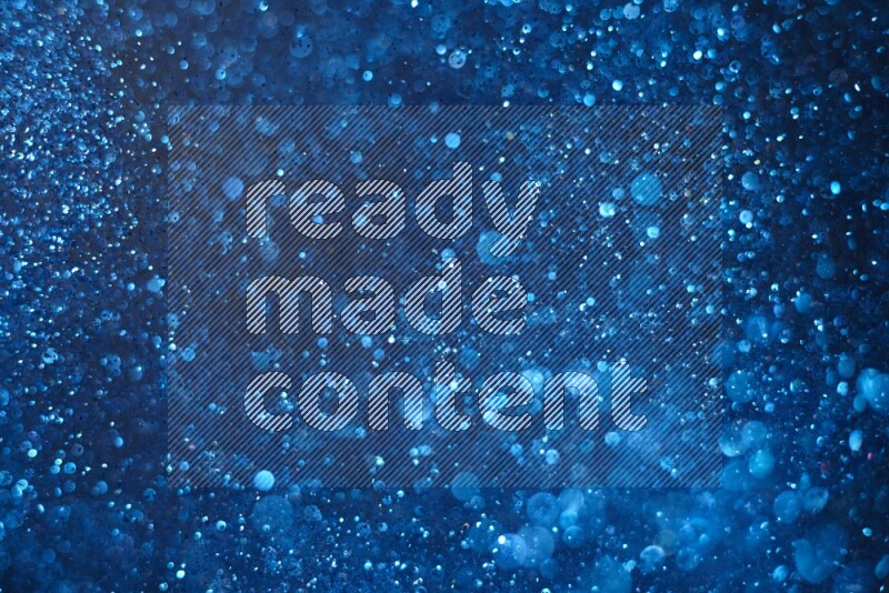 Blue glitter powder isolated on black background