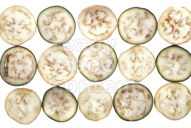 Eggplant slices on illuminated white background