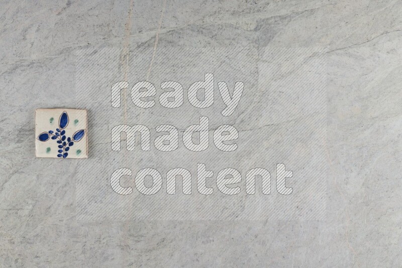 A decorative pottery coaster on grey marble background