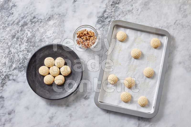 Kahk step by step with its ingredients ghee, sugar, flour, sesame, yeast, water and kahk flavor on grey marble background