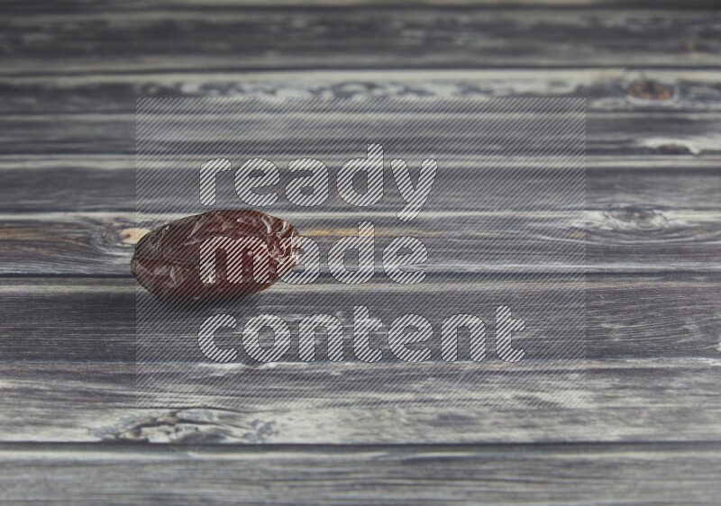 one madjoul date on a wooden grey background