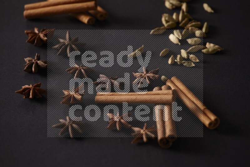 Cinnamon Sticks, Cardamom and star anise on a black background