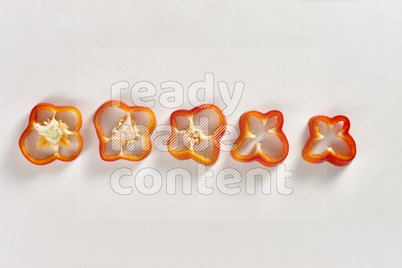 Red bell pepper slices on white background