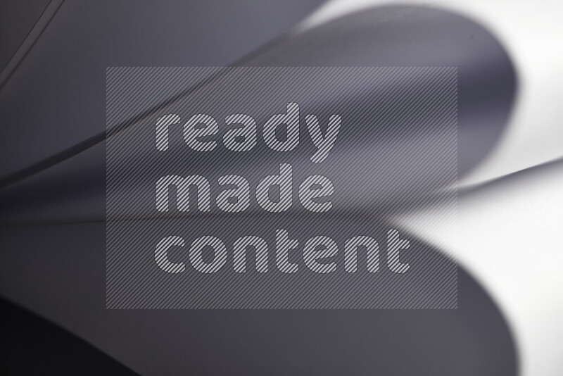 An abstract art showing grey paper sheets arranged in an overlapping curves