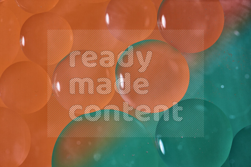 Close-ups of abstract oil bubbles on water surface in shades of green and orange
