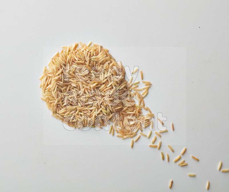 Top-view shot of long grain brown rice on white background