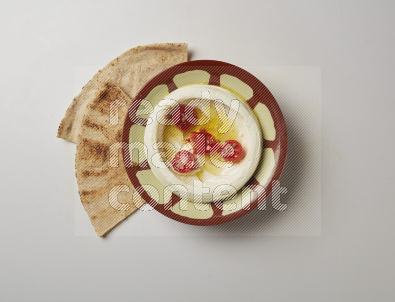 Lebnah garnished with Cherry tomato in a traditional plate on a white background