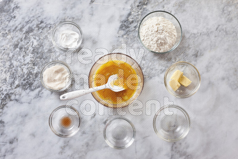 Cookies step by step with its ingredient, flour, butter, brown sugar, egg, vanilla extract, white sugar, chocolate chips and baking soda on grey marble background