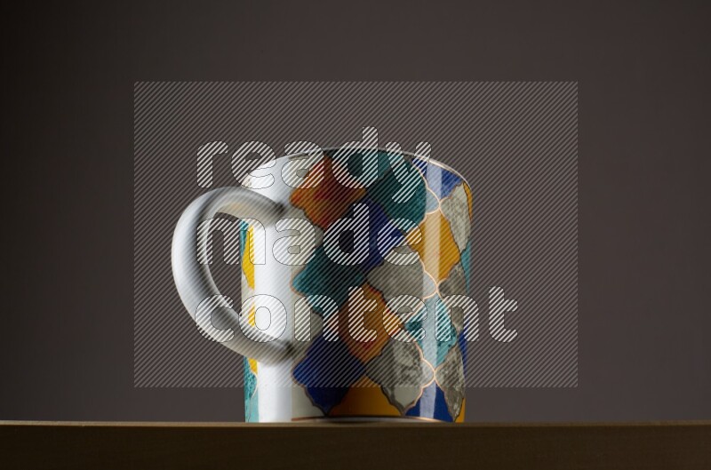 Low angle shot of a decorated cup on grey background