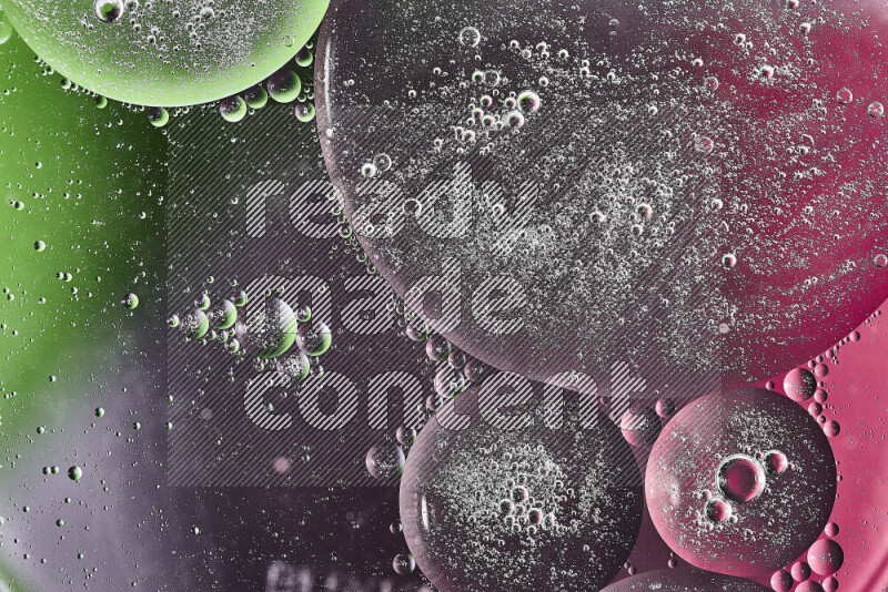 Close-ups of abstract oil bubbles on water surface in shades of green, purple and pink
