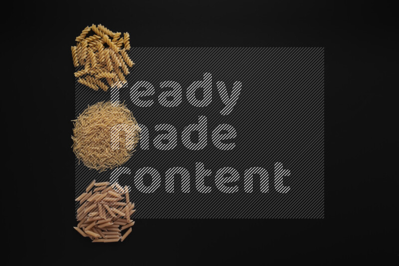 Different pasta types in 3 bunches on black background