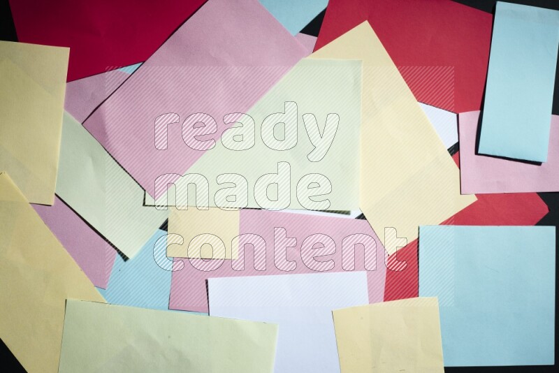 Multicolored paper sheet on black background
