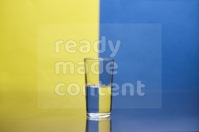 The image features a clear glassware filled with water, set against yellow and blue background