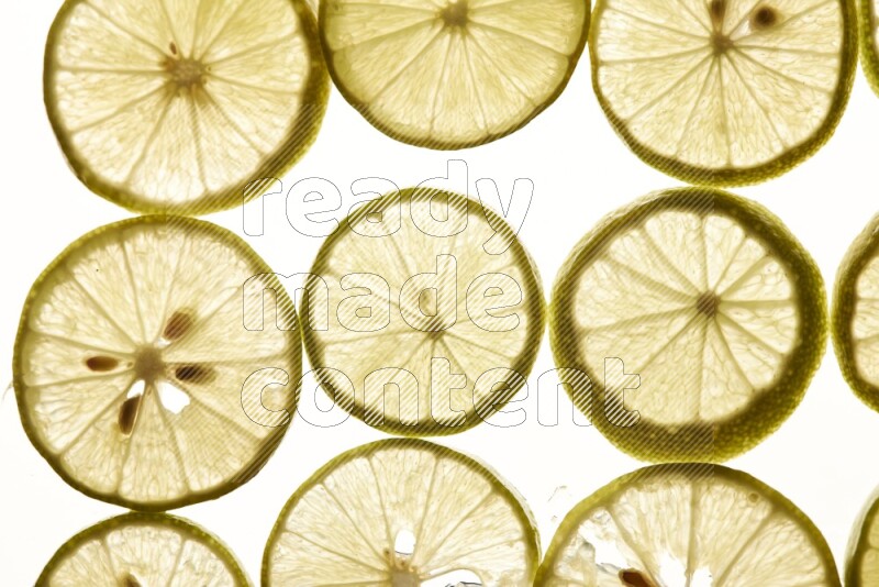 Lemon slices on illuminated white background