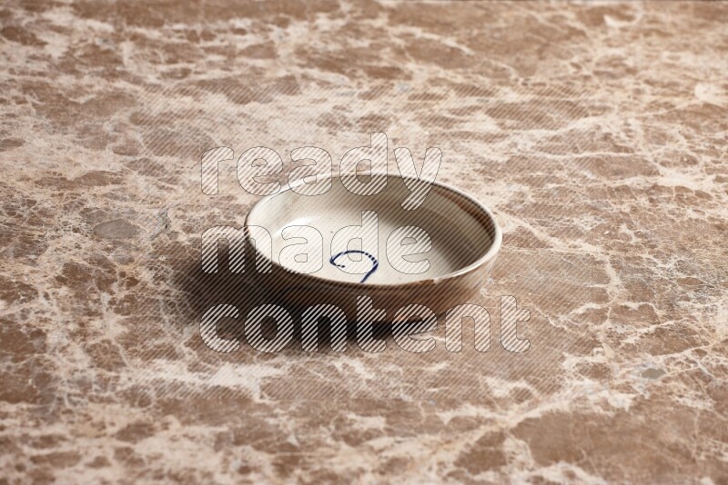 Multicolored Pottery Bowl on Beige Marble Flooring