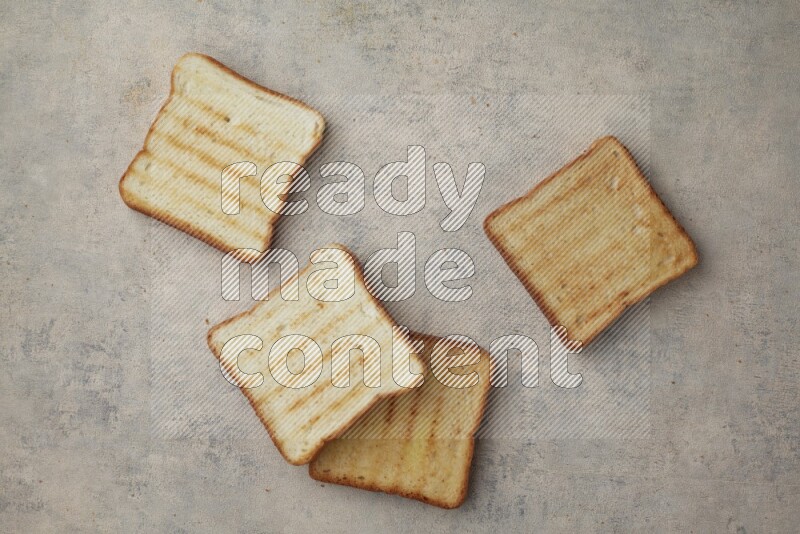 Toasted white Toast slices on a light blue textured background