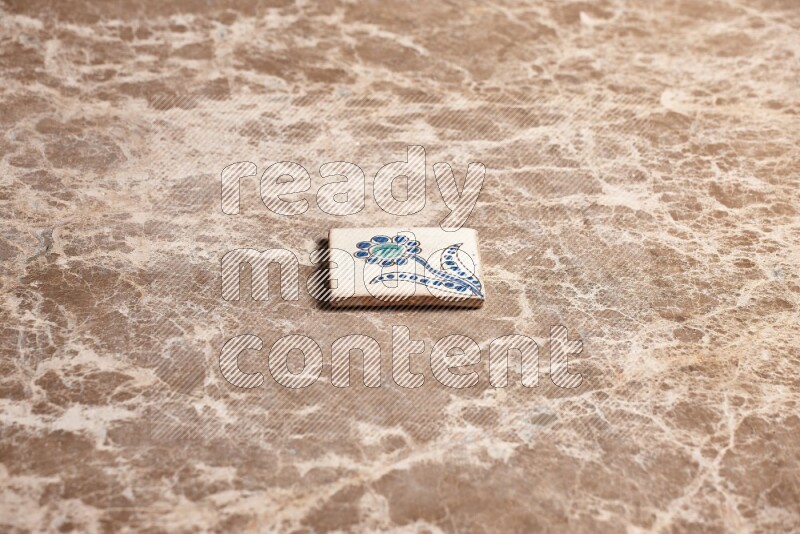 A decorative coaster on beige marble background