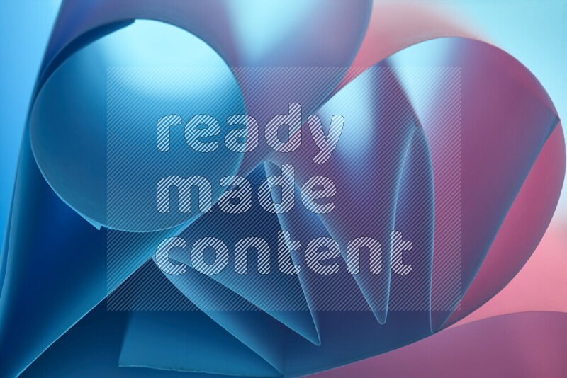 An artistic display of paper folds creating a harmonious blend of geometric shapes, highlighted by soft lighting in blue and pink tones