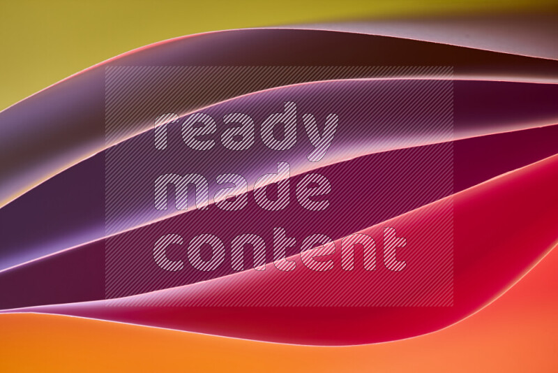 This image showcases an abstract paper art composition with paper curves in different warm gradients created by colored light