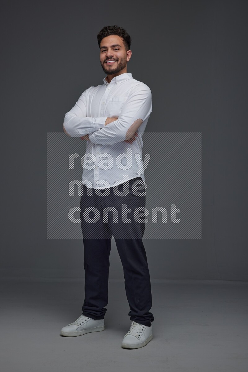 A man wearing smart casual making multi stand poses  eye level on a gray background