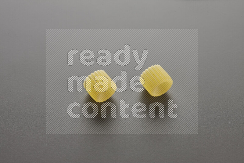 Big rings pasta on grey background