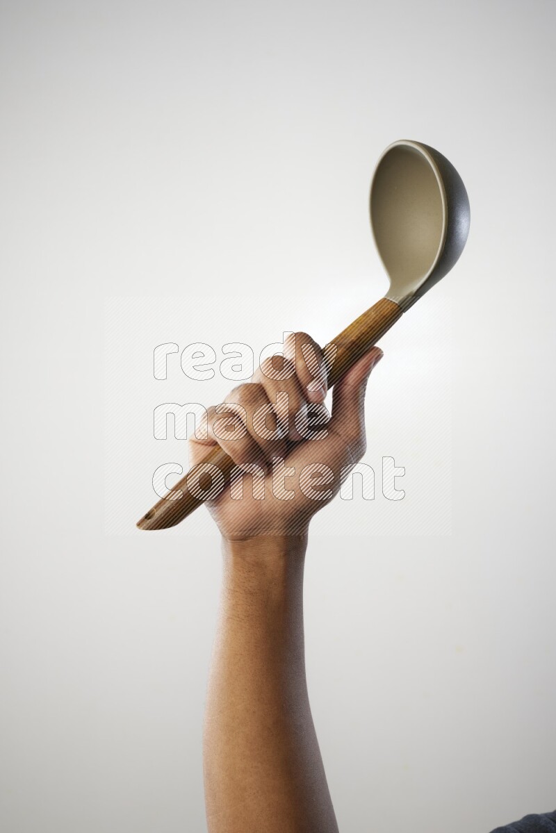 Male Hand Holding ladle on white background