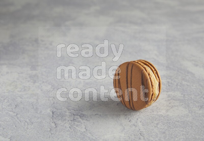 45º Shot of light brown  Almond Cream macaron on white  marble background