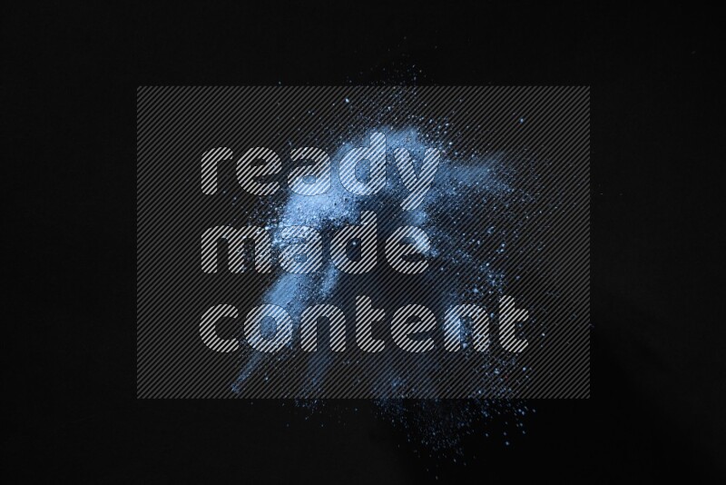 Blue powder explosion on black background